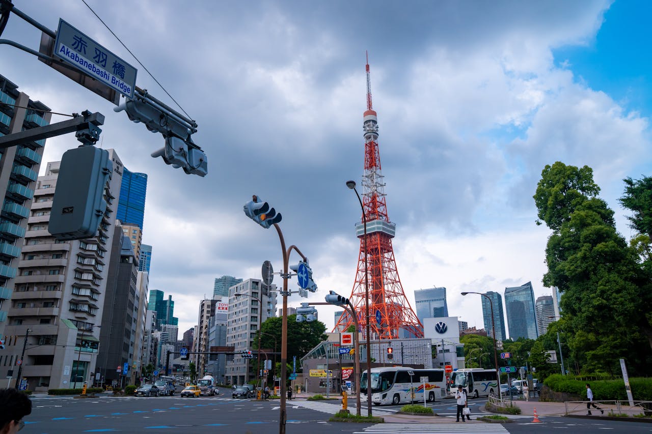 Services-01 Vibrant cityscape featuring Tokyo Tower and Akabanebashi Bridge in Minato, Tokyo. Bright day with bustling urban life.