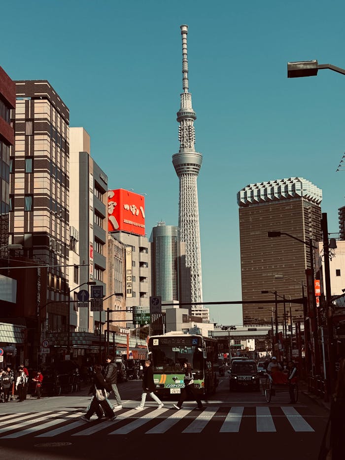 A bustling street scene in Tokyo with the iconic Skytree tower and vibrant urban life.